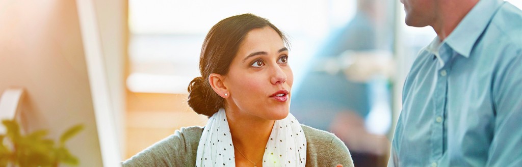 A woman in an office looks up expectantly