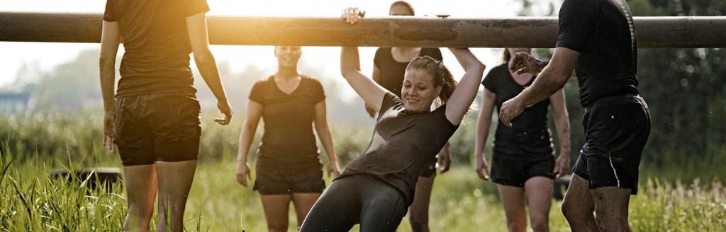 Photo of several people doing a team-building activity in a field